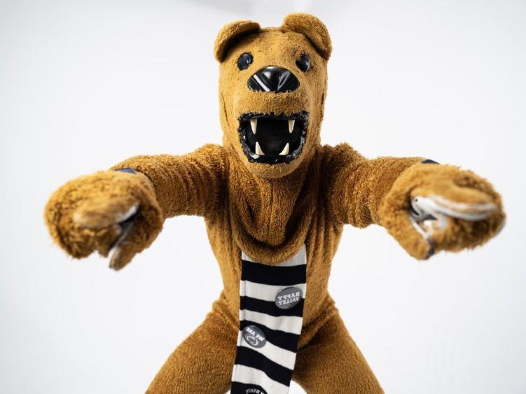The Nittany Lion mascot points to the camera with both hands